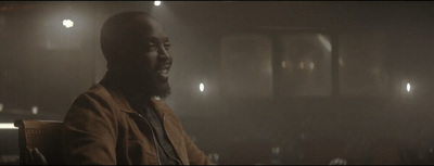 a man sitting in a chair in a dark room