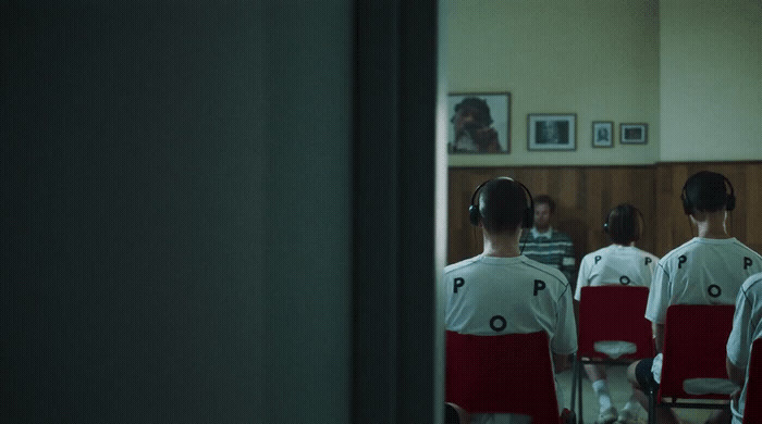 a group of people standing in front of a mirror