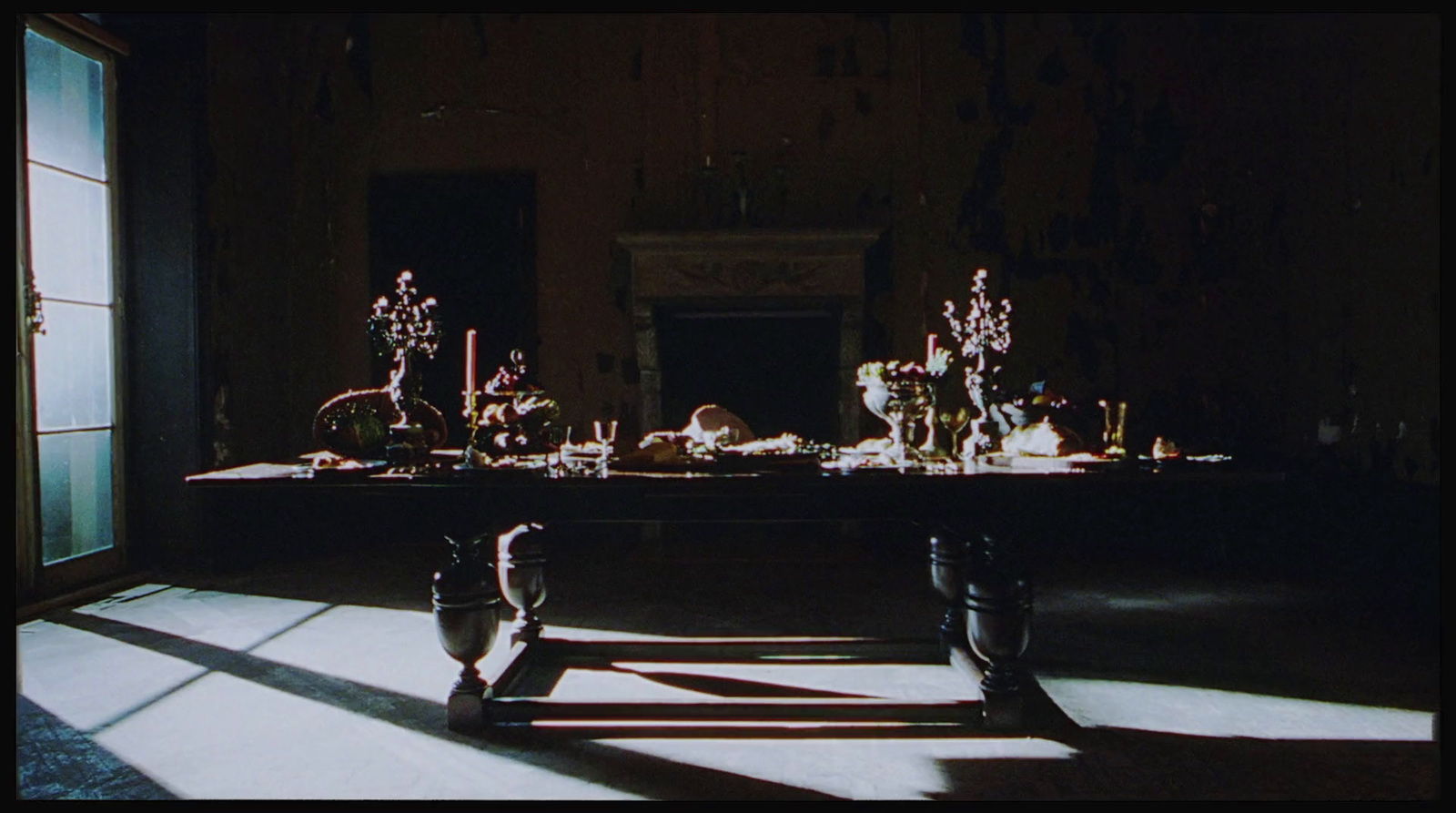 a long table with vases on it in a dark room