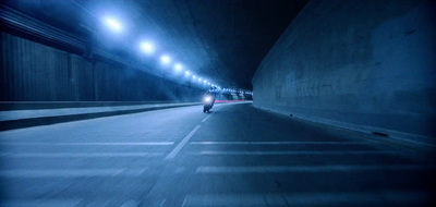 a car driving through a tunnel at night