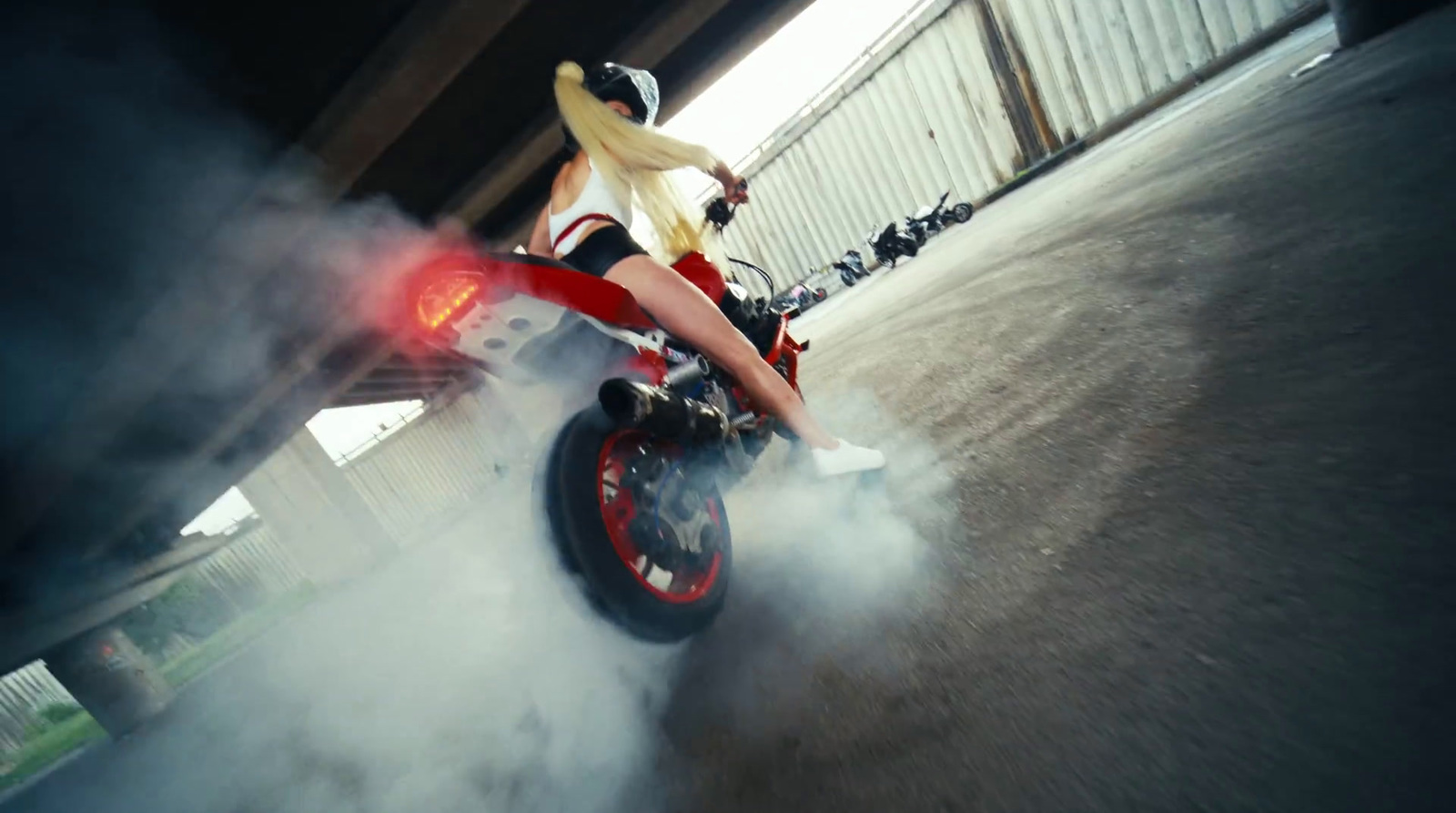 a woman riding on the back of a motorcycle