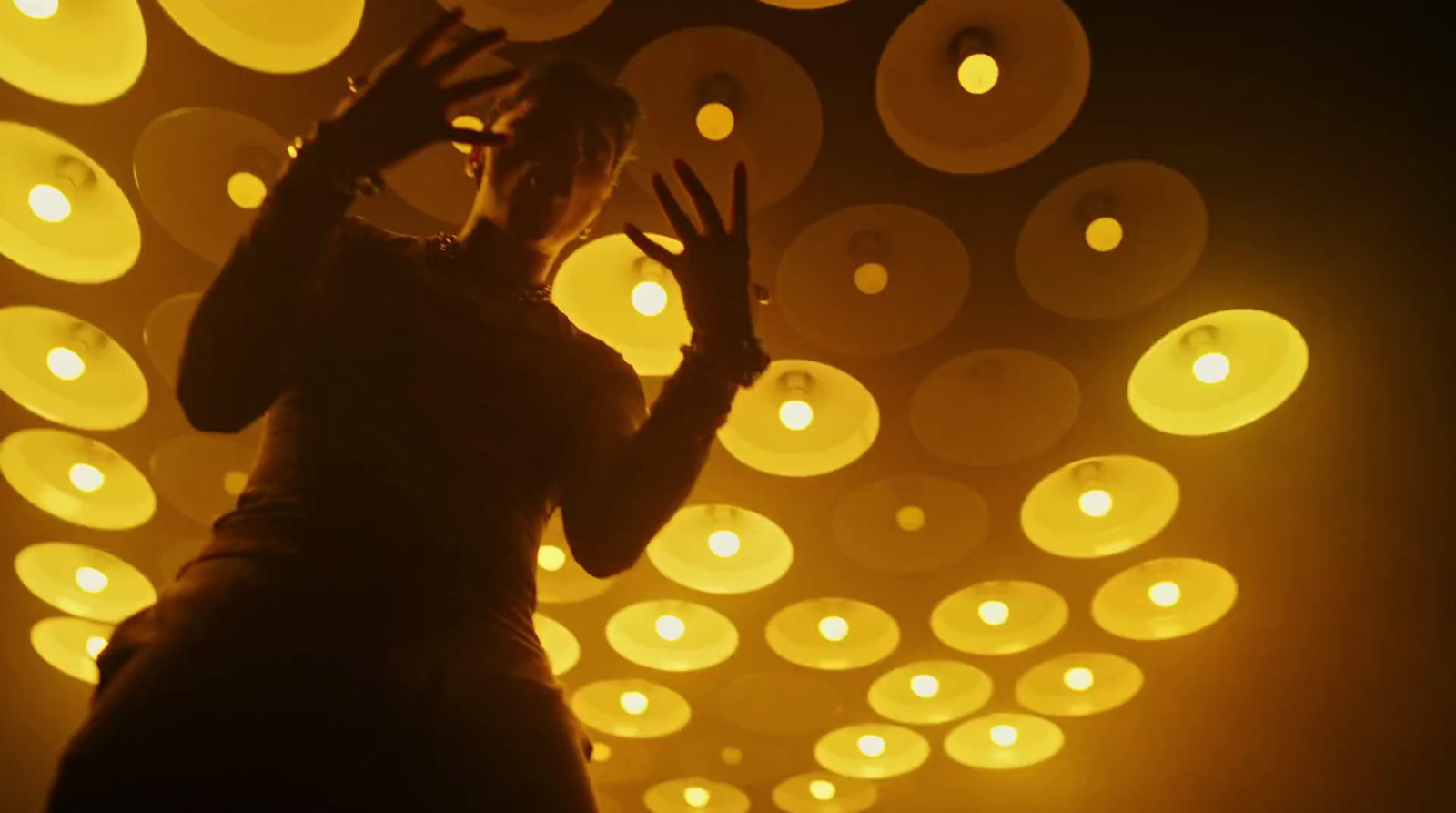 a woman standing in front of a wall of lights