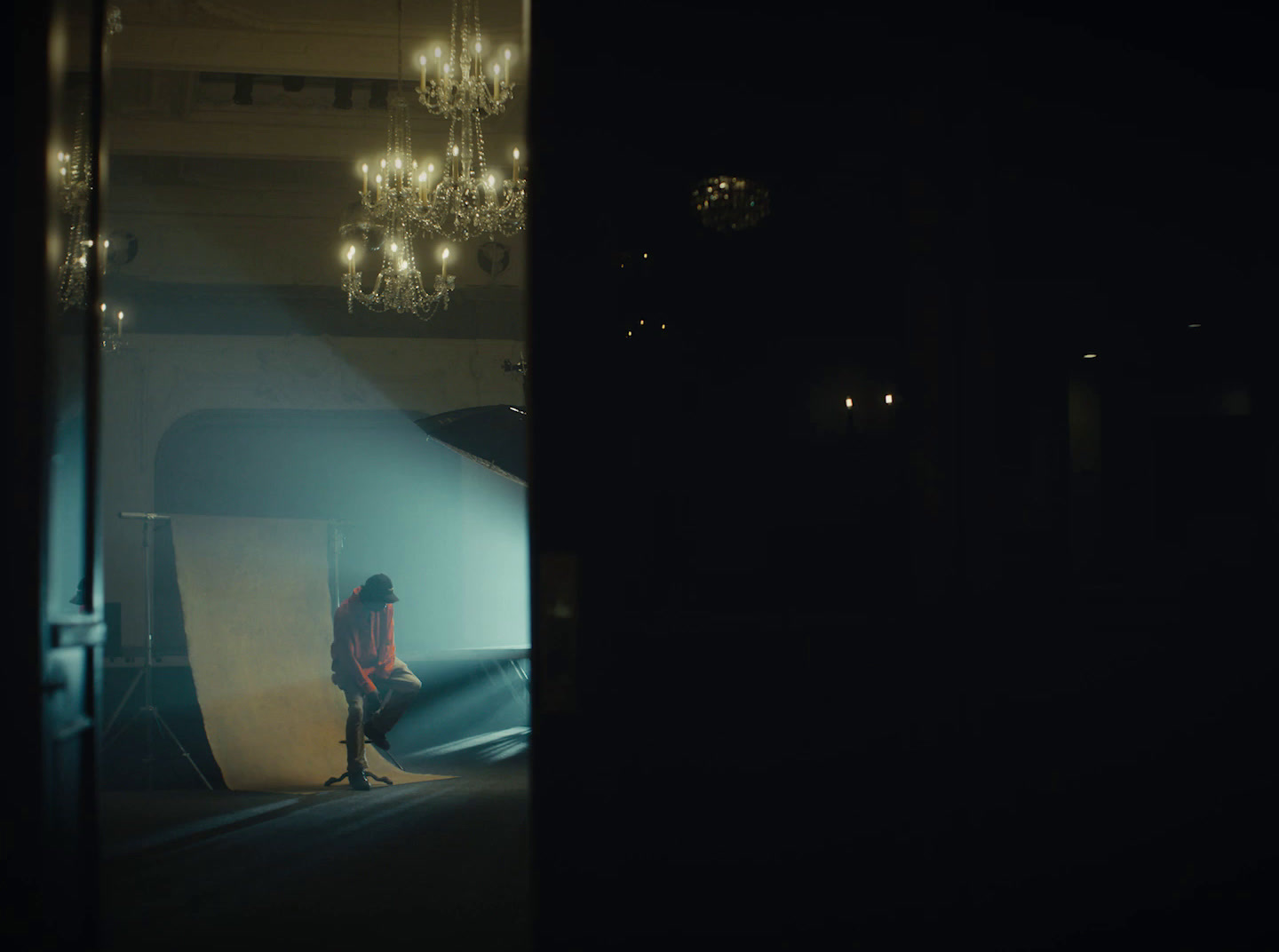 a woman sitting on a chair in a dark room