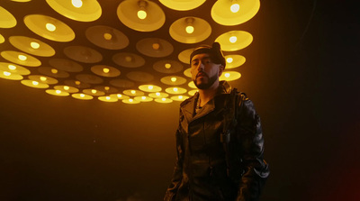 a man standing in front of a ceiling of lights