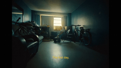 a dark room with a bike and a chair