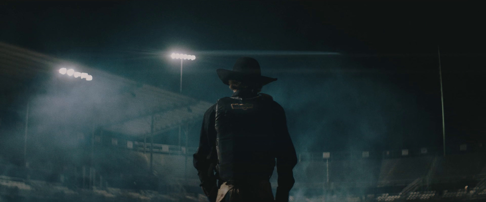 a man standing in a stadium at night