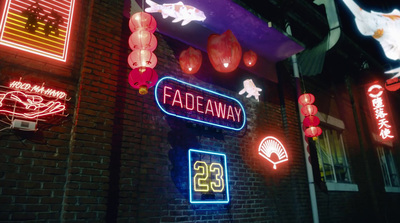 a brick building with neon signs on it