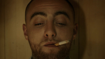 a man with a cigarette in his mouth