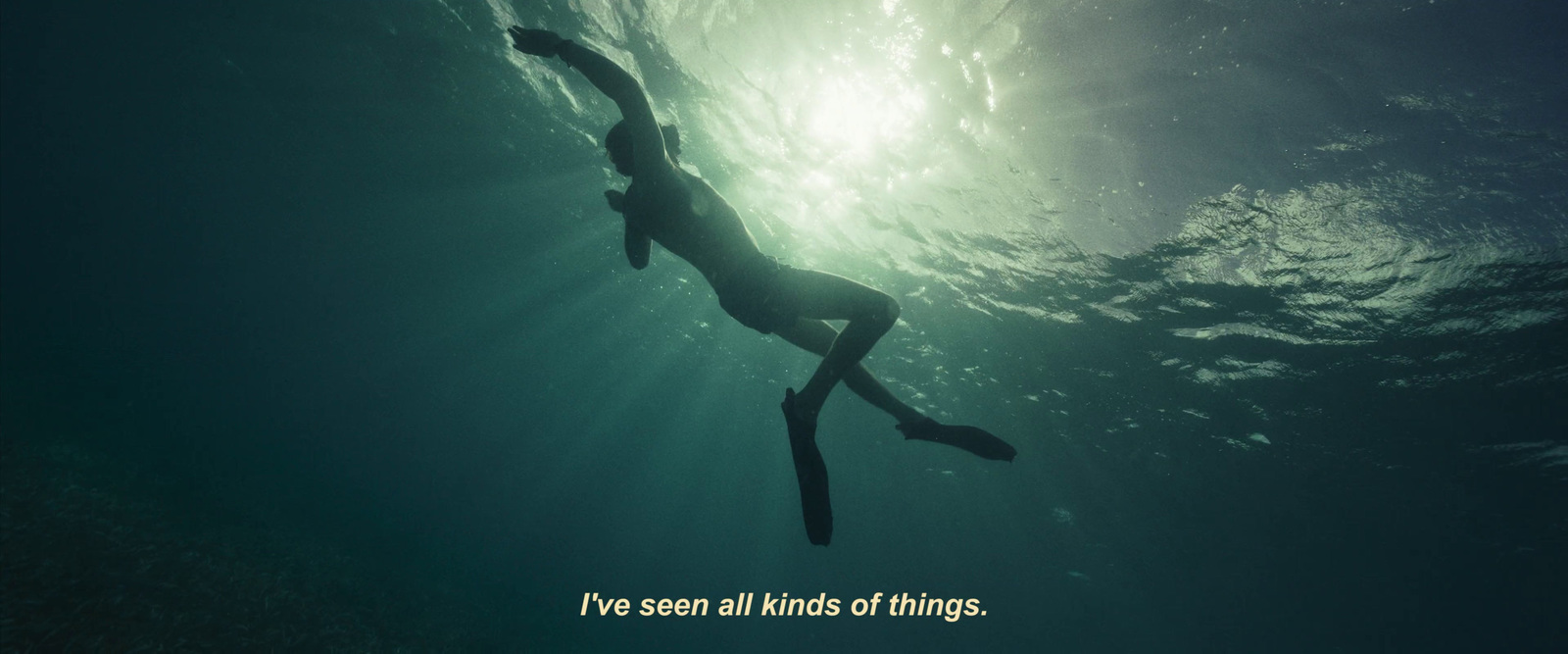 a person swimming in the ocean with a quote above them