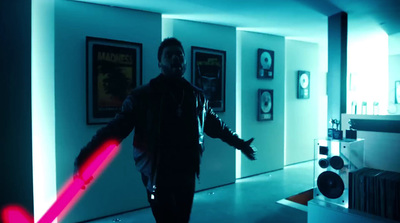 a man holding a red light saber in a room