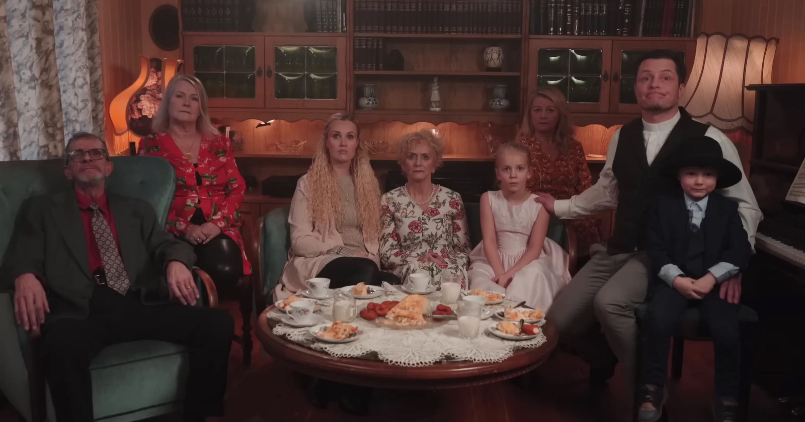 a group of people sitting around a table with food on it