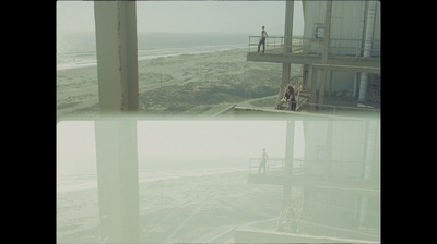 a couple of people standing on top of a building