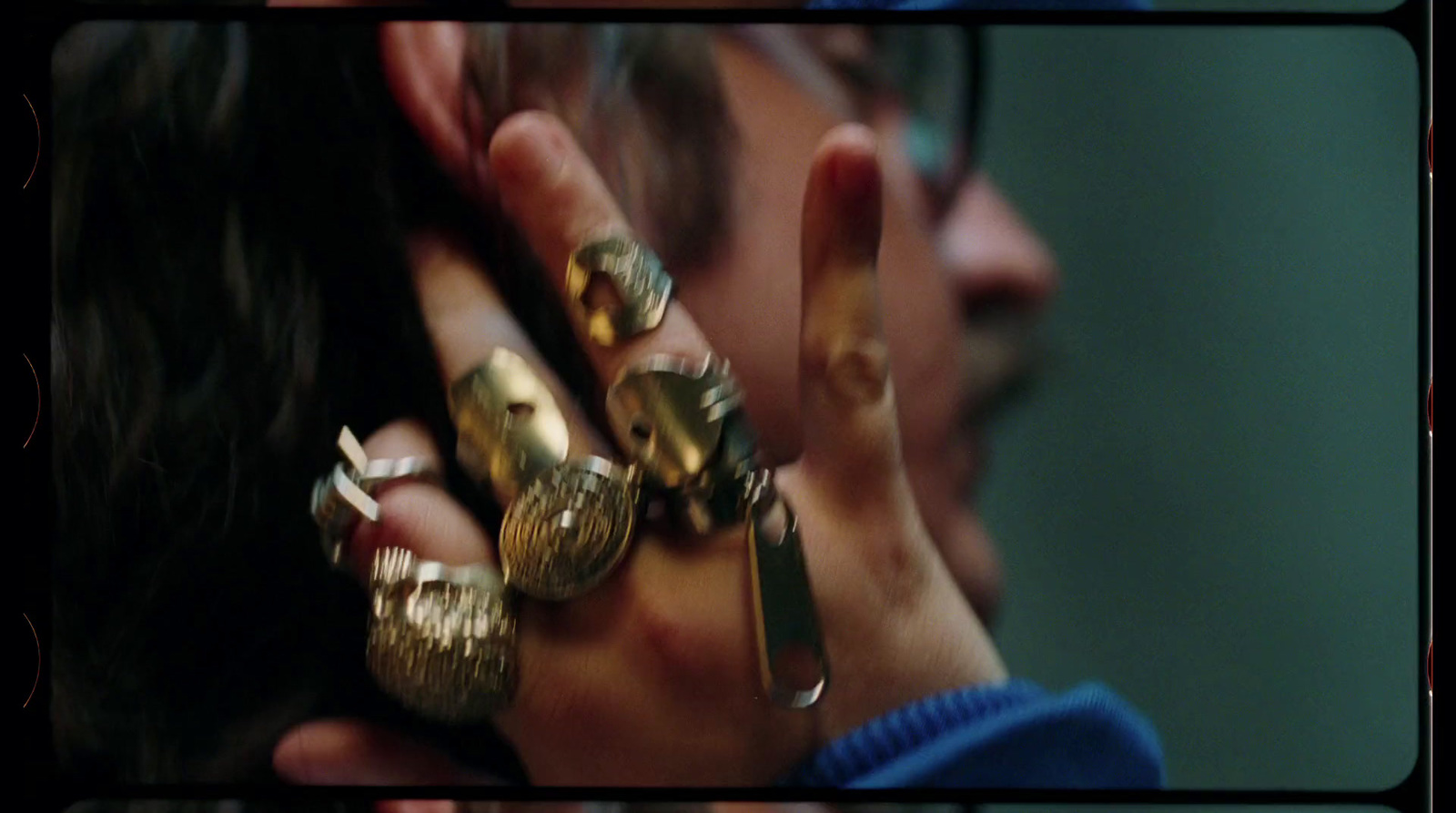 a woman holding a bunch of rings in her hand