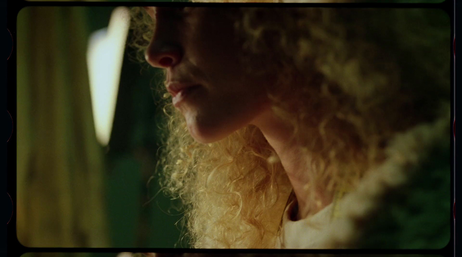 a close up of a woman with curly hair