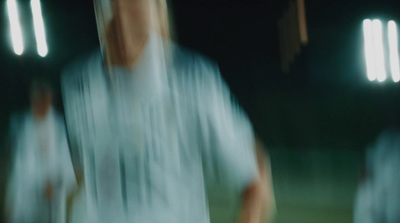 a blurry photo of a soccer player on the field