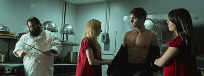 a group of people standing in a kitchen