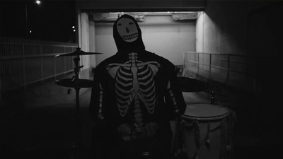 a man in a skeleton costume playing drums