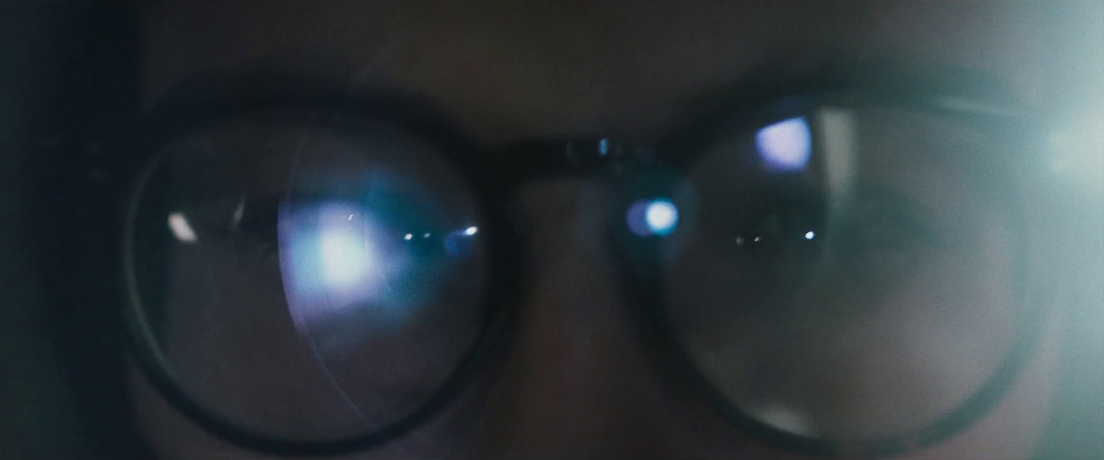 a close up of a person wearing a pair of glasses