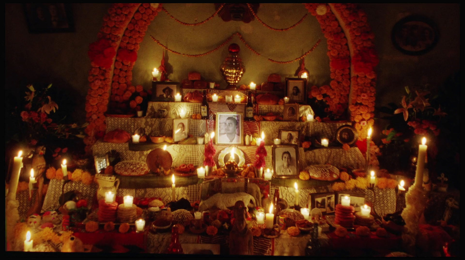 a room filled with candles and pictures on the wall