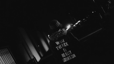 a black and white photo of a person holding a sign