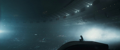 a person standing on top of a stage in front of a crowd