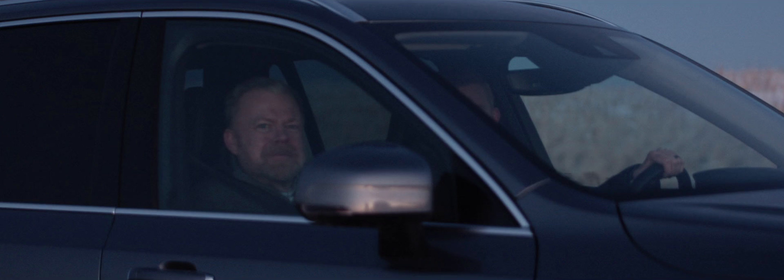 a man driving a car in the dark