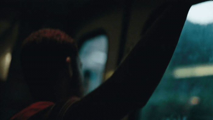 a person sitting in a car looking out the window