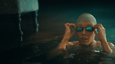 a woman in a swimming pool wearing goggles