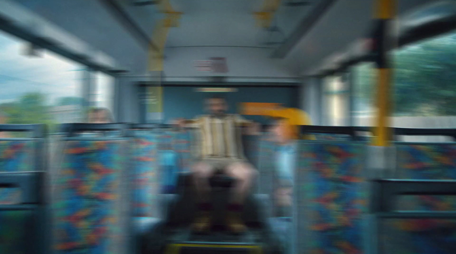 a blurry photo of a man sitting on a bus