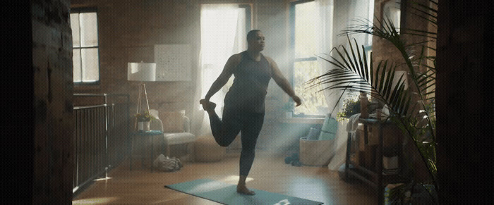 a woman standing on a yoga mat in a living room