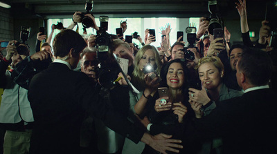 a group of people taking pictures with their cell phones