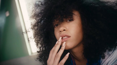 a close up of a person with curly hair