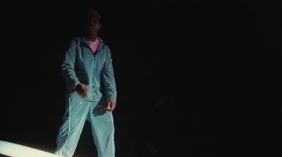 a man standing on a surfboard in the dark