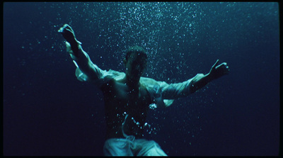 a man standing under water with his arms outstretched