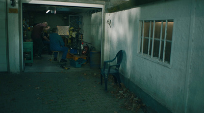 a man and a woman standing in a garage