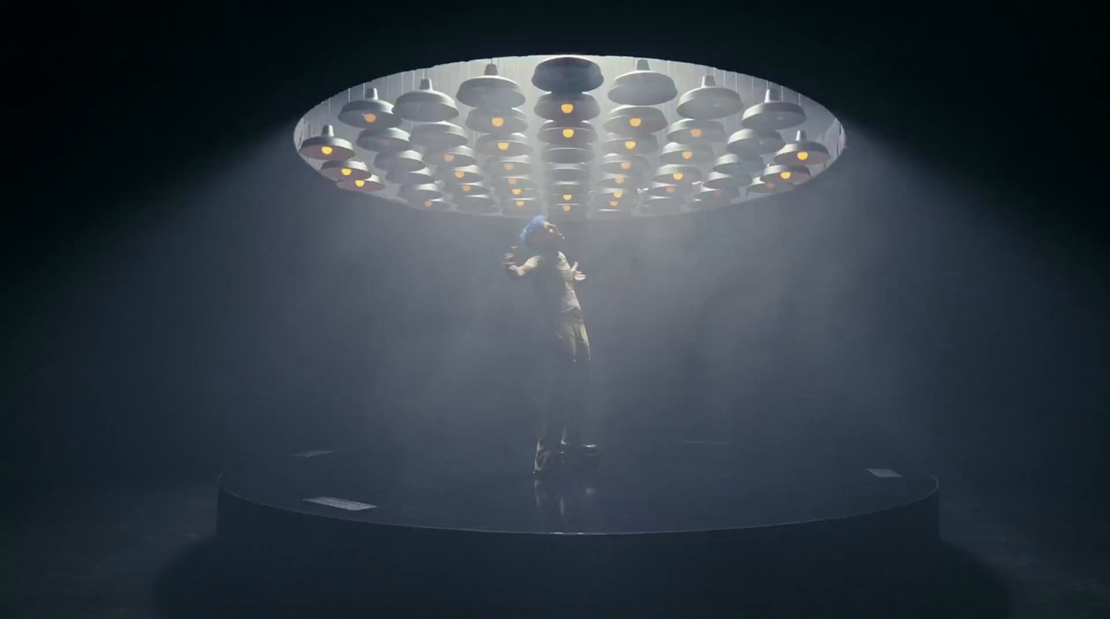 a person standing in front of a large light fixture