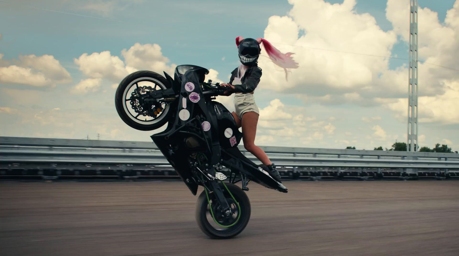 a woman riding on the back of a motorcycle