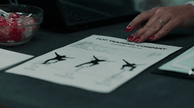 a woman's hand on top of a piece of paper