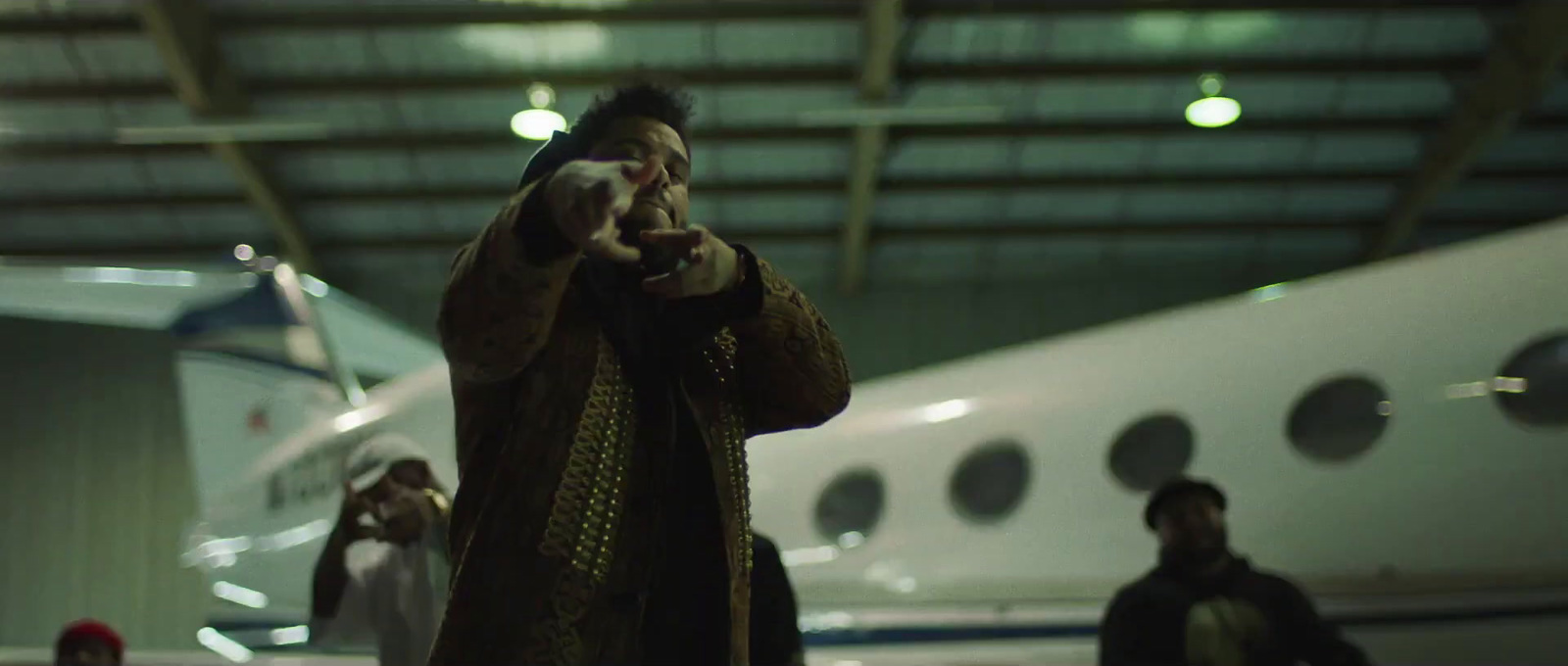 a man standing in front of a plane talking on a cell phone