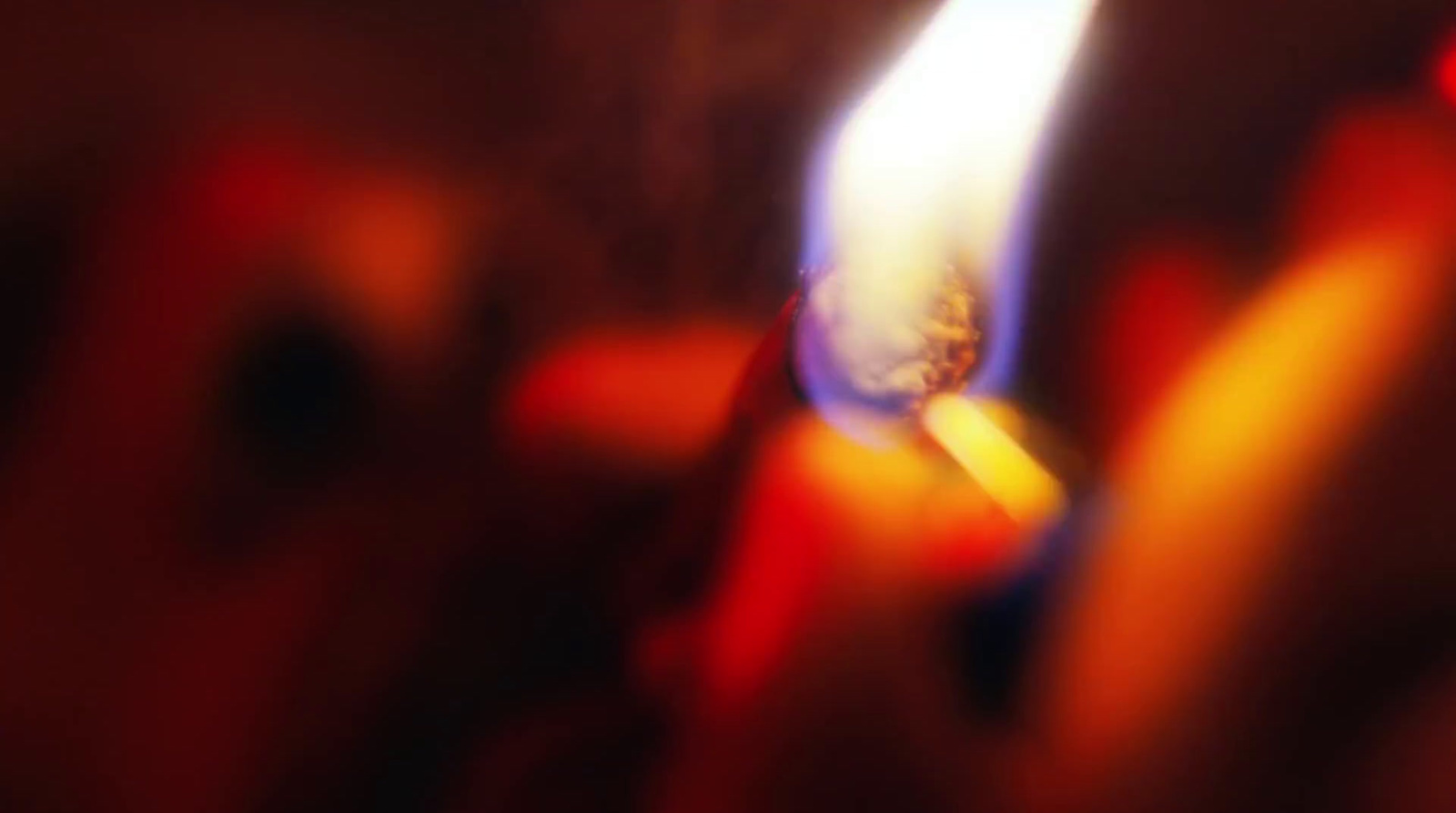 a close up of a lit candle with a blurry background