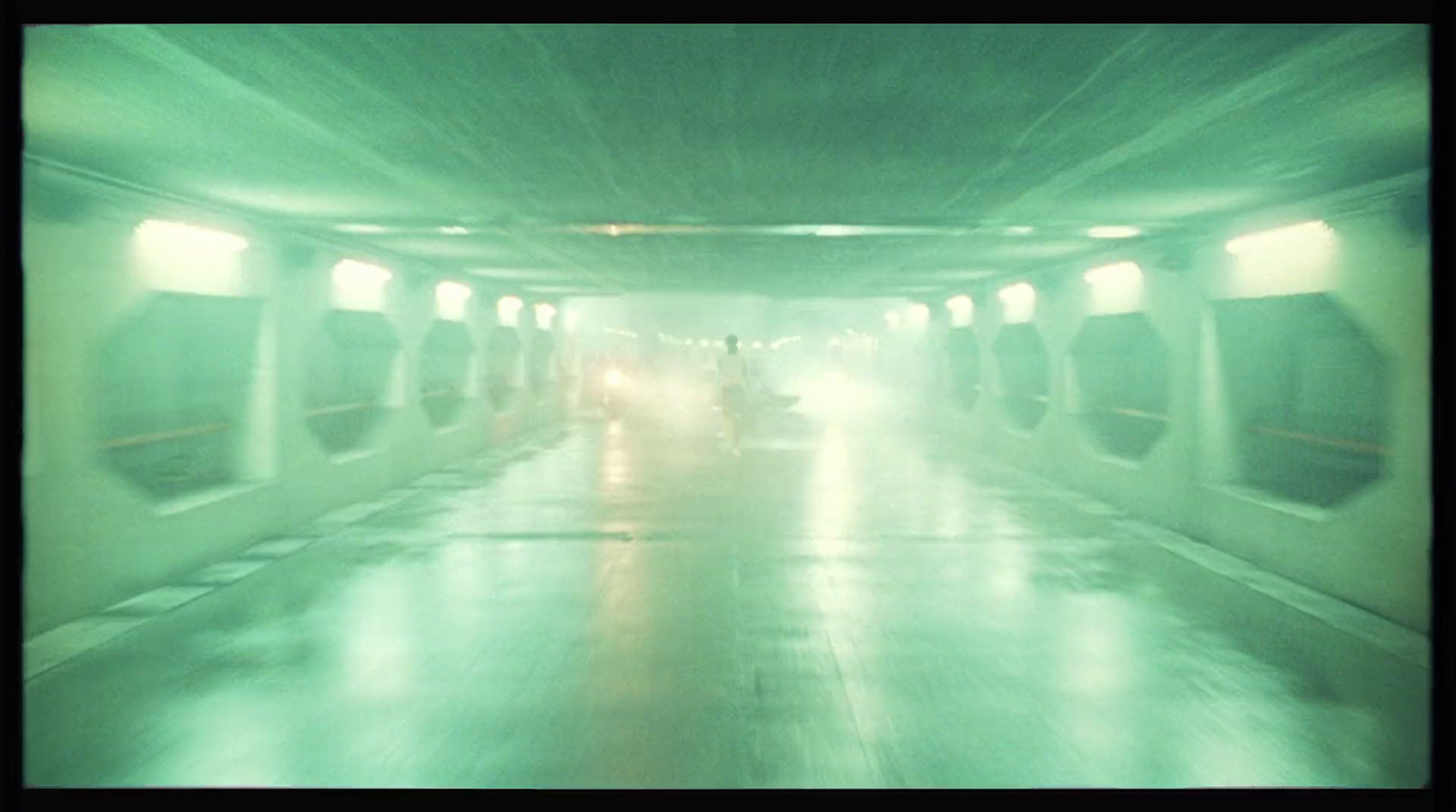 a car driving through a tunnel on a rainy day