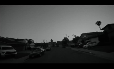 a black and white photo of cars parked on a street