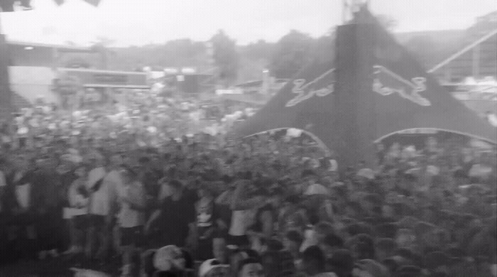 a crowd of people standing around a stage