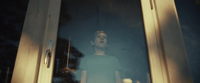 a woman standing in front of a glass door