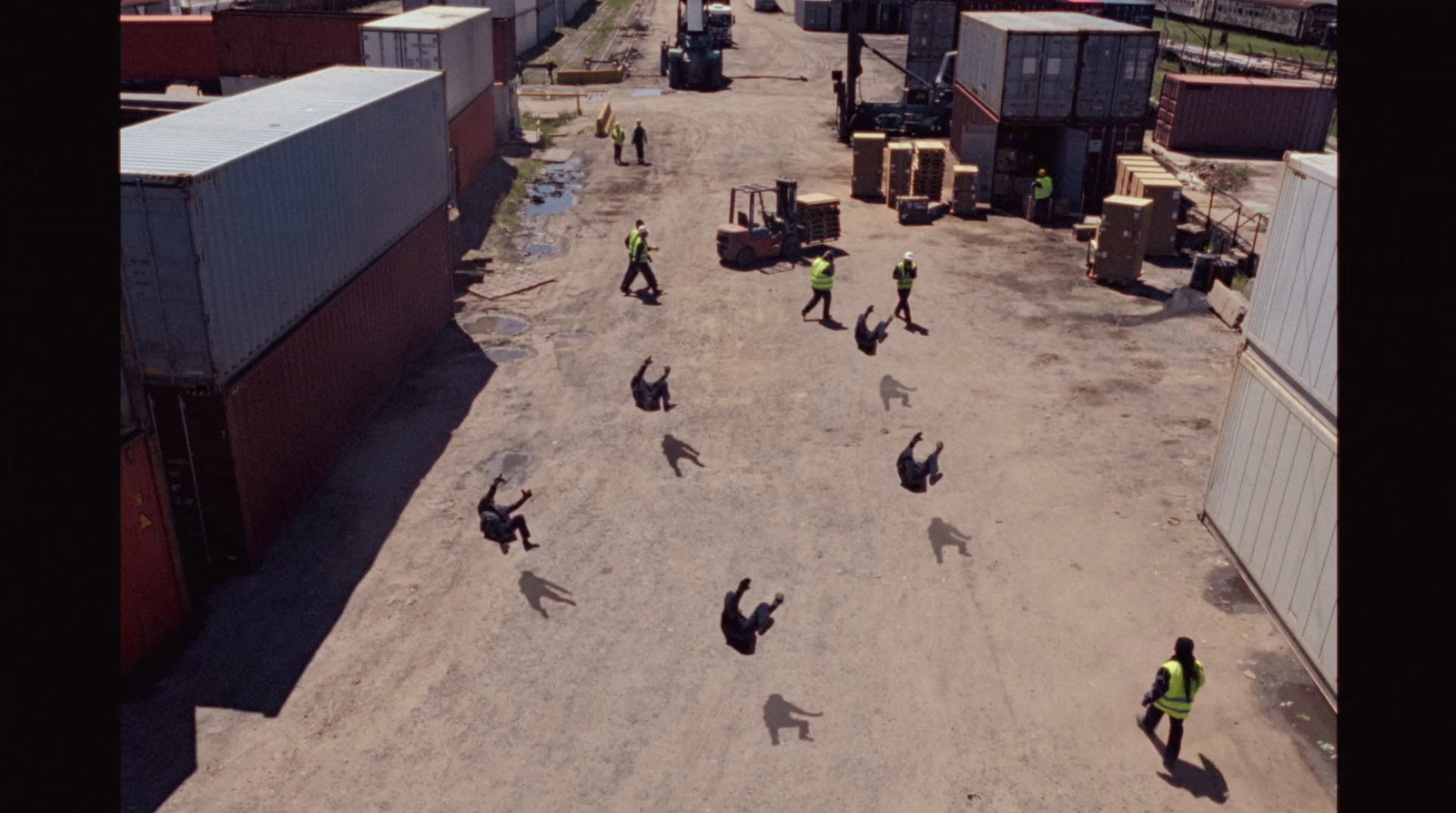 a group of people standing on top of a dirt field