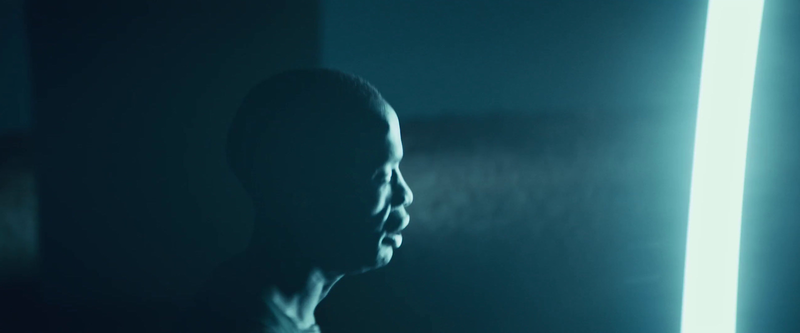 a man standing in front of a mirror in a dark room