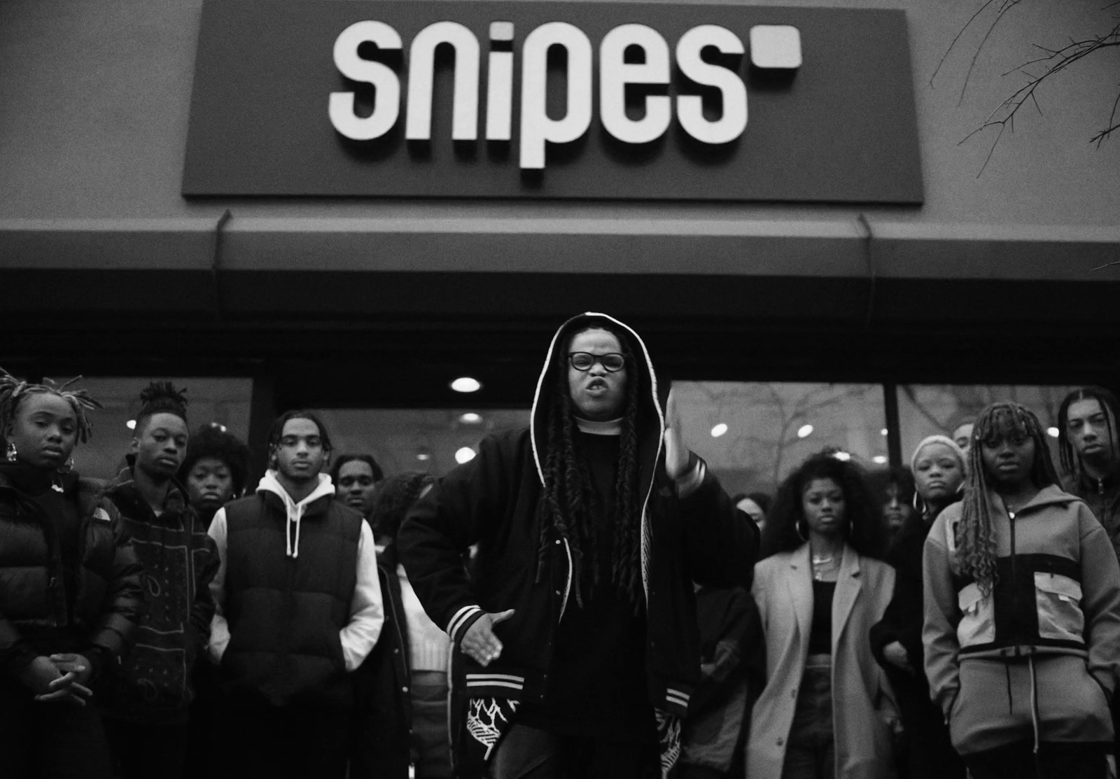 a group of people standing outside of a store