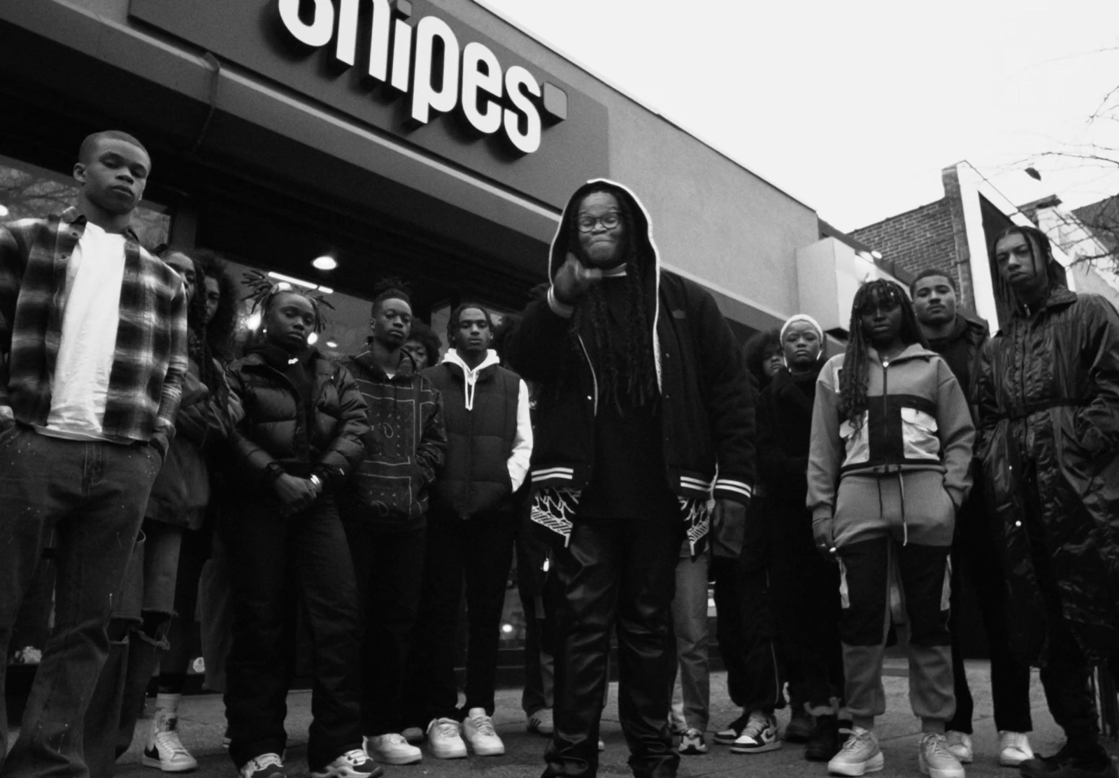 a group of people standing in front of a store