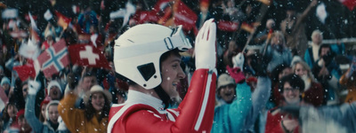 a man in a red and white uniform waves to a crowd