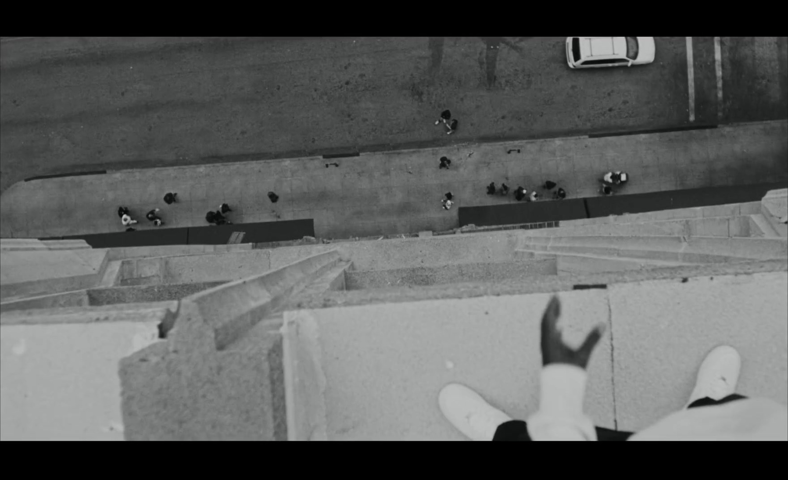 a black and white photo of a person standing in front of a wall